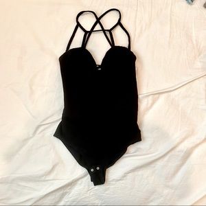 black bodysuit with geometric straps